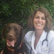 Dr. Cara Daniel owner of Tidewater Veterinary in Mount Pleasant, South Carolina with her pet Tucker the Chocolate LAbrador