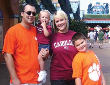 Clemson/Carolina Fans: Michelle & Johnnie Calhoun with their children in team colors