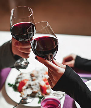 Charleston Wine Pairings - two glasses of wine raised during a date