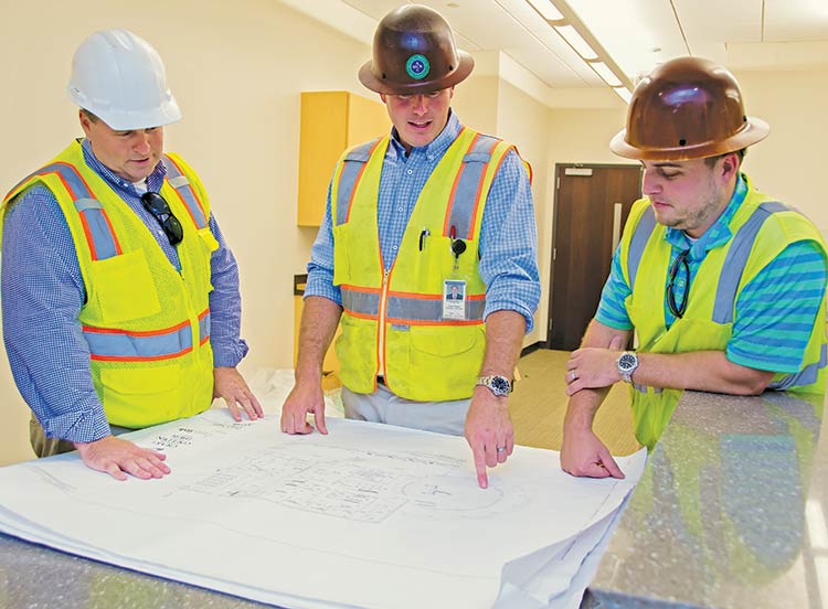 Matt Farrell, Brooks Blumenthal and Bryce Howeie review floor plan for the new Town Hall