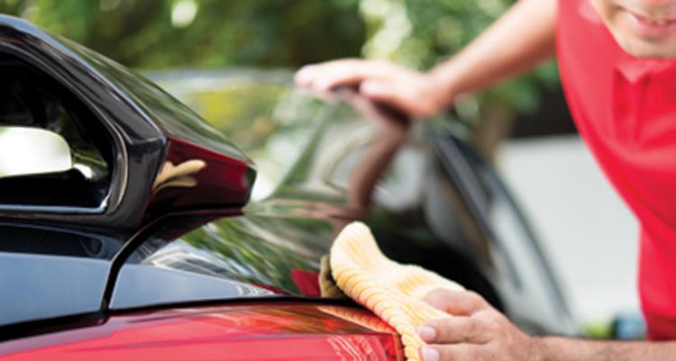 Wiping down a car after a car wash