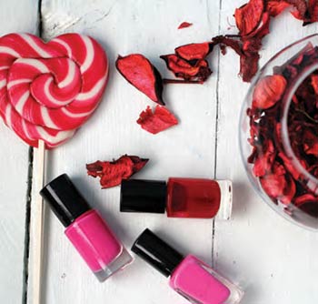 Heart-shaped lollipop, fingernail polish and flower petals