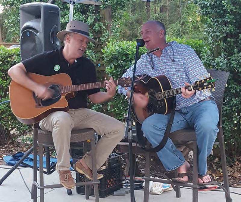 Mayor Will Haynie, left, per forms with Bobby Houck, lead singer of The Blue Dogs