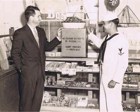 Walter D. Toler with a customer at Mount Pleasant Seafood in 1947.