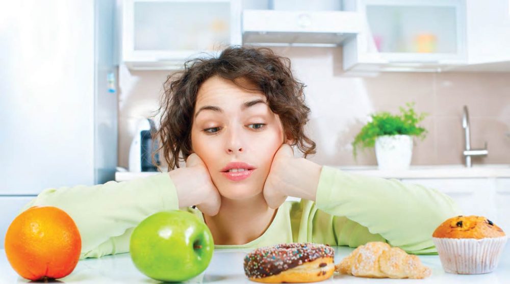 A woman considers options to satisfy her sweet tooth