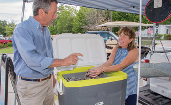 U.S. Rep. Mark Sanford talks with Pauline Blackwell of Lady J Shrimp at the Mount Pleasant Farmers Market. Facing page: Sanford discusses issues with Jeff and Ruth Lloyd.