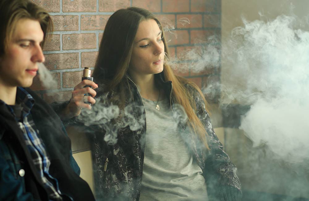 Two teens vaping.