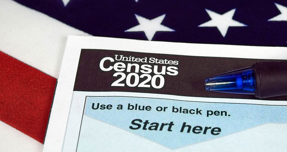 2020 Census form with an American flag in the background