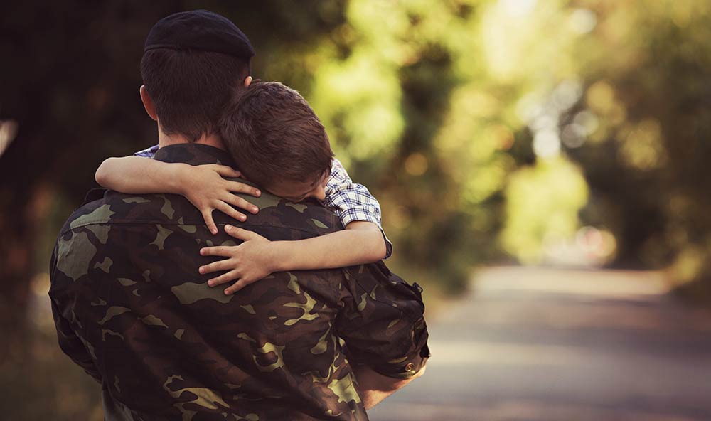 A soldier carrying a child