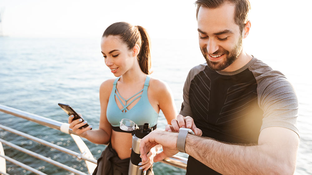 An active couple using an app to help manage exercise and burn calories