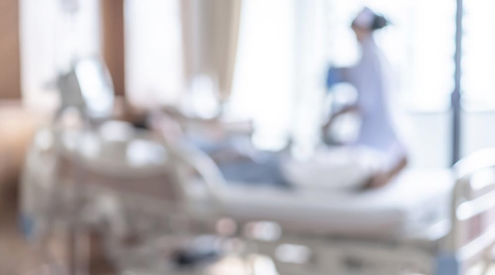 A blurry photo of a nurse with her patient in a hospital