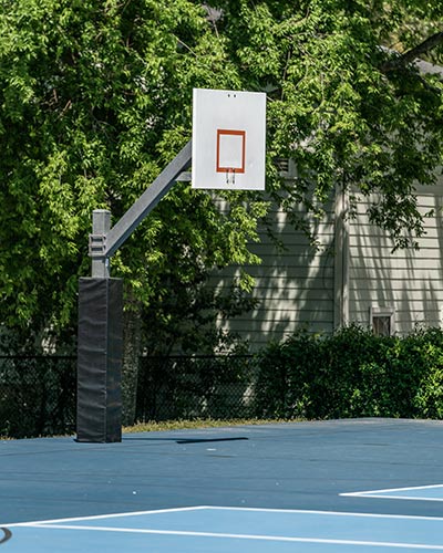 Backboard with no hoop on a basketball court closed during the COVID-19 Pandemic