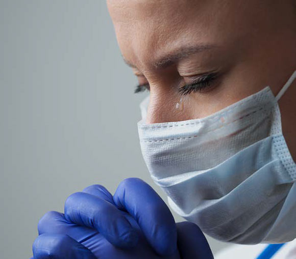 A nurse crying during prayer