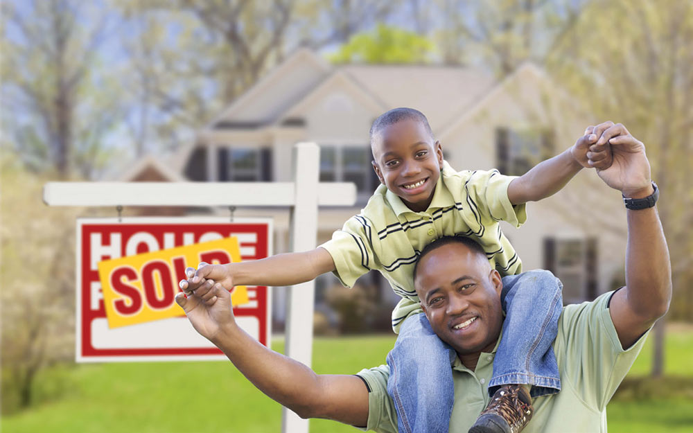 A son and his father smile after their house has been sold.