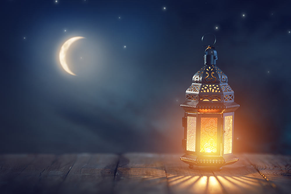 A lantern provides light against the dark sky.