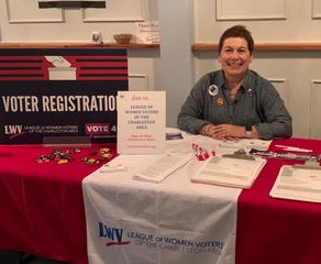Joan Zaleski, Director of Voter Services at the Charleston Area League of Women Voters manning a voting booth