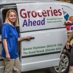 Groceries Ahead's Dan Caruso and Wendi standing by a Groceries Ahead delivery van.