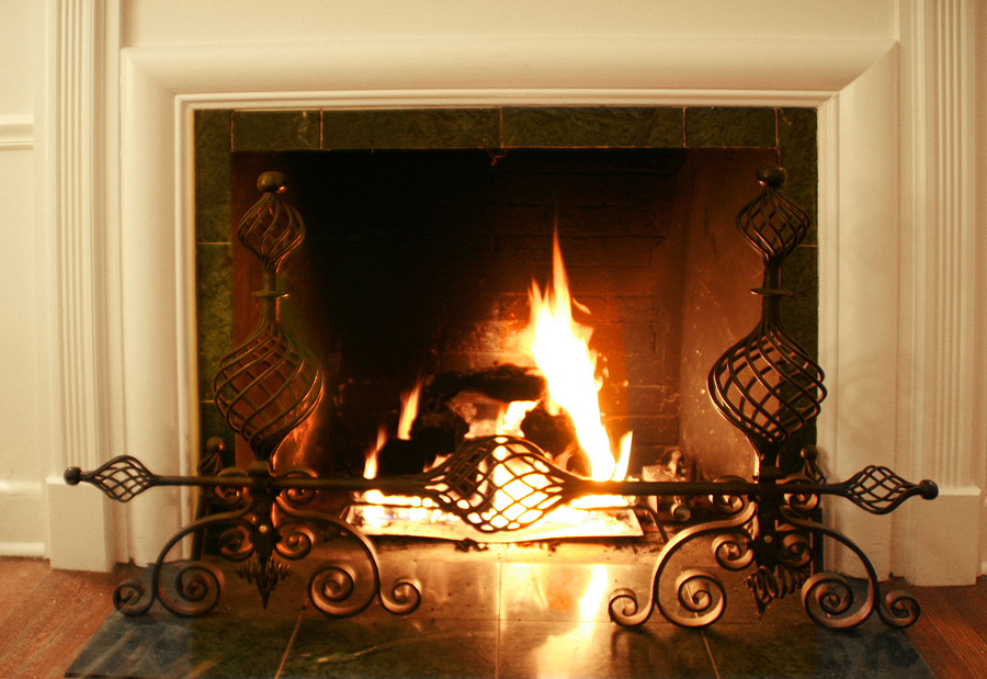 A gas log fireplace burns, warming the family room.