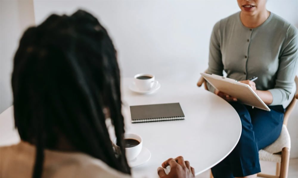 A woman talks to her friend about important documents as she prepares for her future. Preparing for the future is important, even if its difficult.