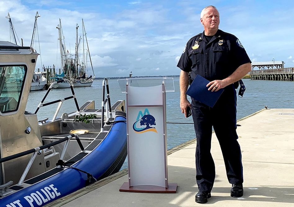 Mount Pleasant, SC Police Chief Ritchie stands next to a new Mount Pleasant PD boat