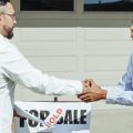 A realtor and home buyer sake hands after the sale of a home. Photo credit Kindel Media on Pexels.