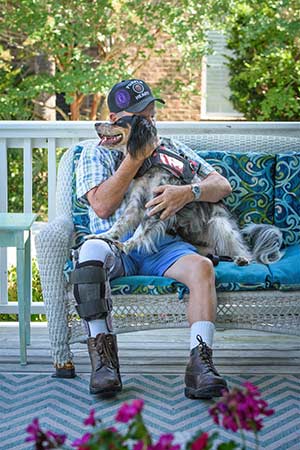 John Beahm shares a calming moment with his PTSD service dog, Sadie.