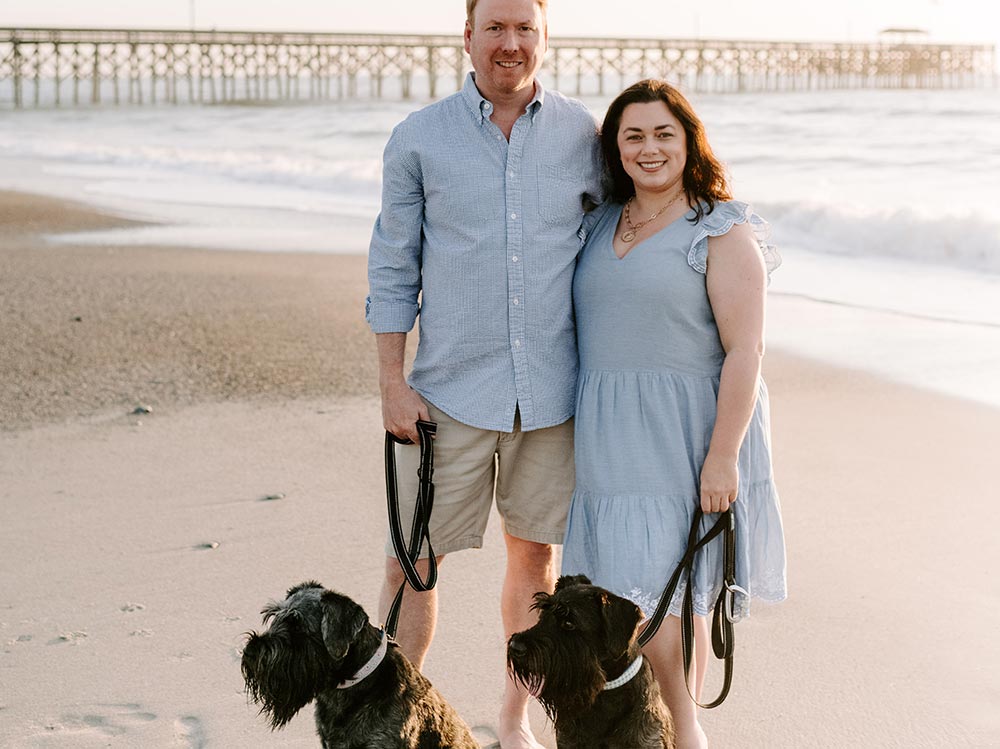 The Hart family enjoying a walk on the Pawleys Island coast with their dogs.