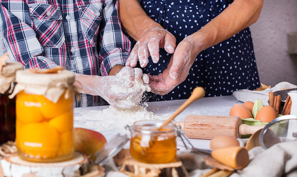 A couple follows a recipe, cooking at home.