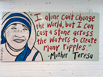 Mother Theresa quote displayed inside incubator. "I alone can't change the world, but I can cast a stone across the waters to create many ripples." - Mother Teresa.