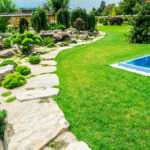 A wonderfully landscaped yard with a pool.