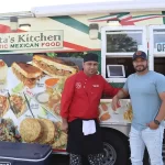 Erik Hernandez and José Cruz in front of their food truck parked at 1340 Chuck Dawley Blvd.
