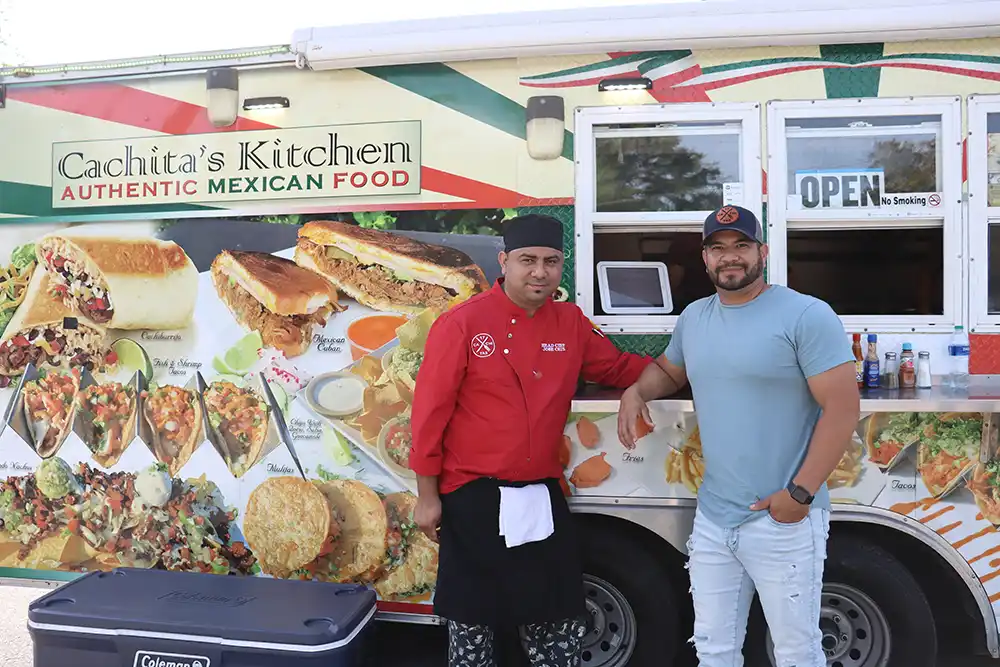 Erik Hernandez and José Cruz in front of their food truck parked at 1340 Chuck Dawley Blvd.