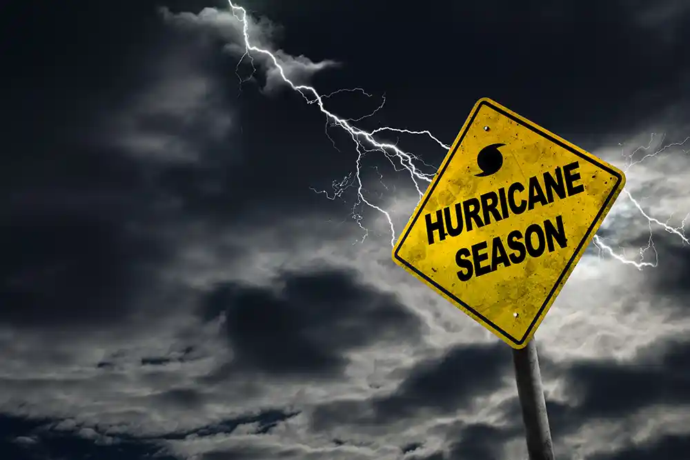 "Hurricane Season" road sign with a stormy, dark sky in the background