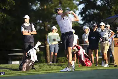 Golfer Matt Moloney during his follow through swing watches the ball flying off into the distance