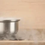 A pot on a stove top smoking