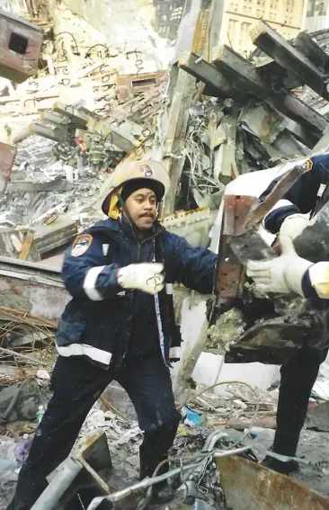 Working on top the Ground Zero pile passing debris from one rescuer to another searching for survivors.