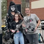 School of Rock owner Matt Mcfarland, his wife Mandy (general manager) and his dad Steve McFarland dressed as Gene Simmons from KISS.