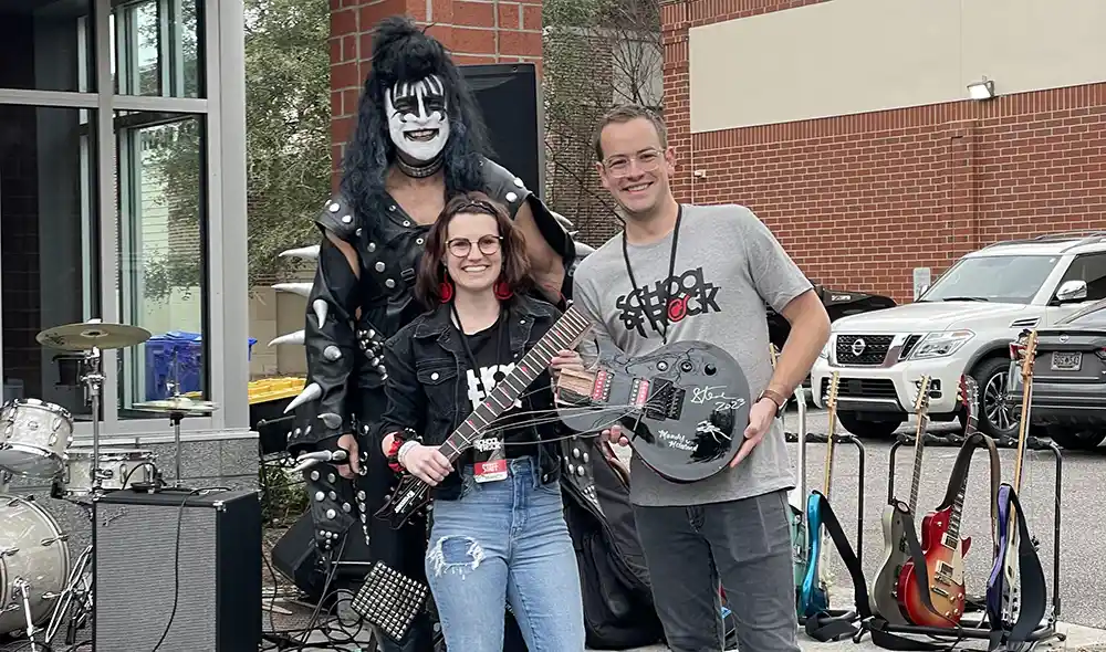 School of Rock owner Matt Mcfarland, his wife Mandy (general manager) and his dad Steve McFarland dressed as Gene Simmons from KISS.