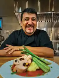 Raul Sanchez smiles with one of his tasty creations