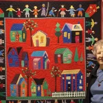 Jan Donovan stands next to one of her quilts.