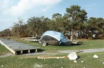 A boat lies on its side on the grass after Hurricane Hugo deposited it there.