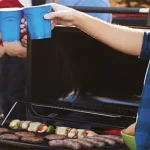 Tailgating - a clipped photo of a couple of guys at a tailgate, enjoying some Tailgating food.