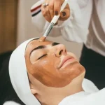 An aesthetician performs a facial treatment.