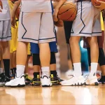 Basketball teams at mid-court