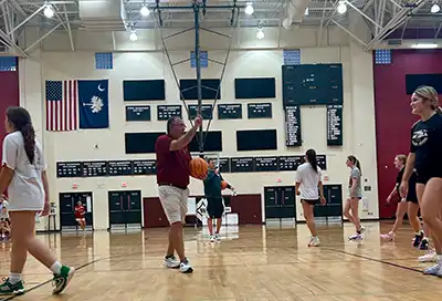 Coach Jeff Emory leads drills and plays at a Wando Lady Warriors basketball practice.