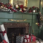 A fireplace, mantle, living room couch decorated for the holiday