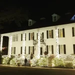 Kaminski House Museum lit up outside with decorative lights.