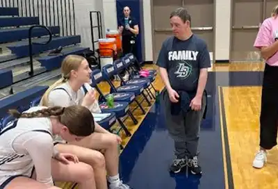 Lucy Beckham Lady Bengals Basketball Coaching assistant Mark talks over a practice drill with LB player.