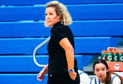 OCA Coach Mandy anxiously watches play during a home game.