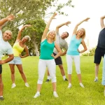 A group of people exercise outdoors